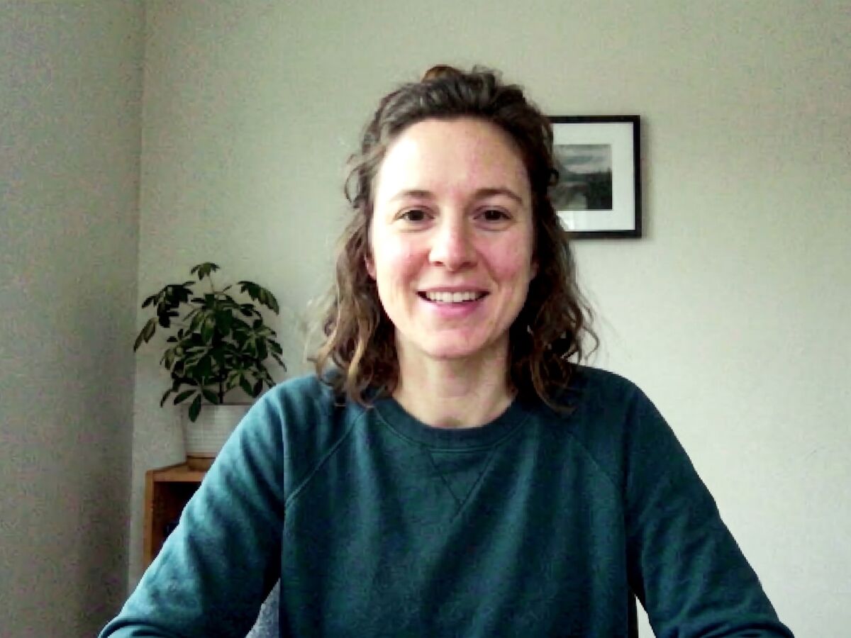 A woman on a video call in a grainy, soft, low-resolution image.